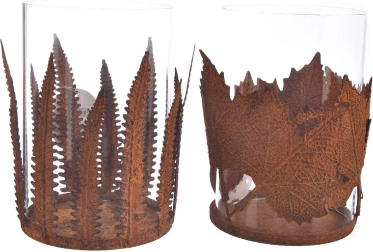 Decorative glass and metal candle holder with a leaf motif in a rusty patina